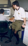 Man in pantyhose and shorts in the office