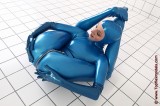 Flexible girl in a  latex catsuit