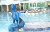 Bianca encased in semitransparent blue latex, fountains and clothing styles
